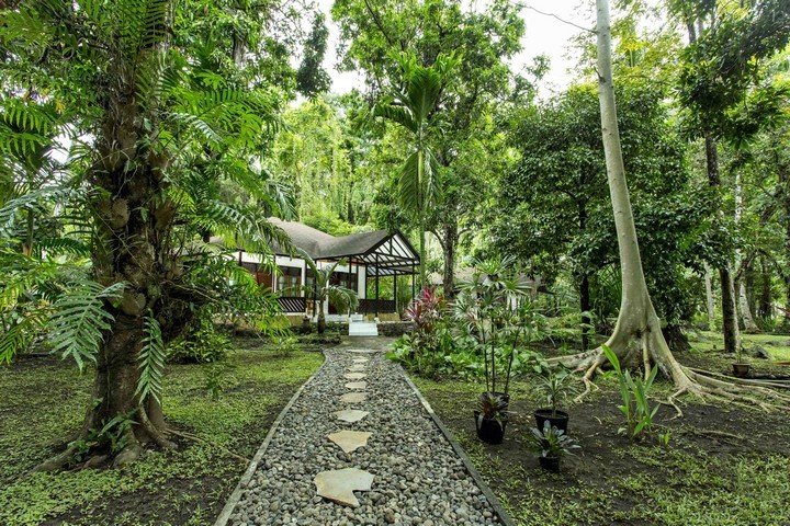 Murex Manado Resort bungalow in tropical garden